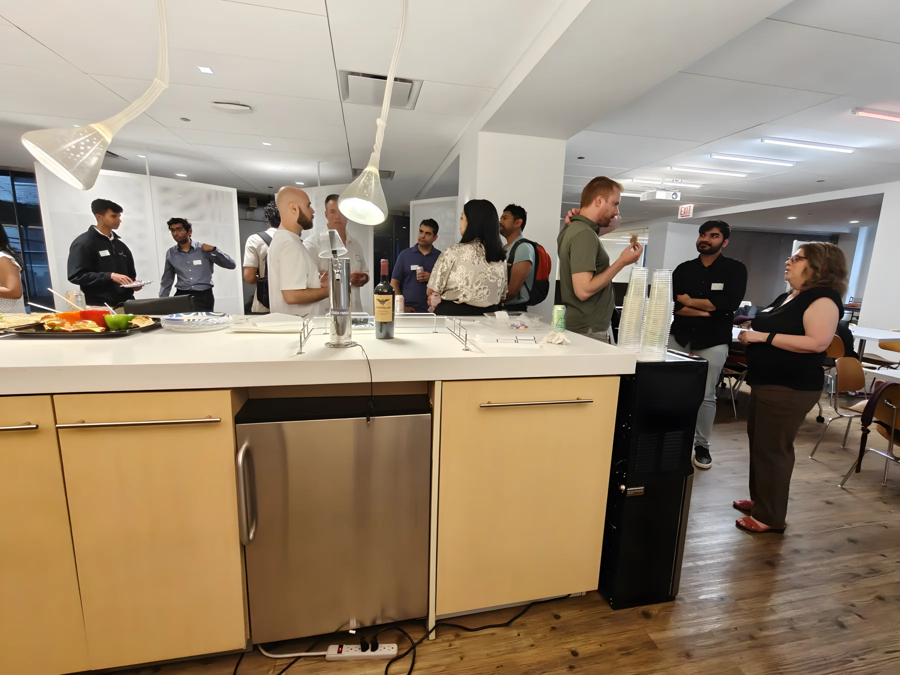ChiPMA attendees talking around a kitchen island at a community event