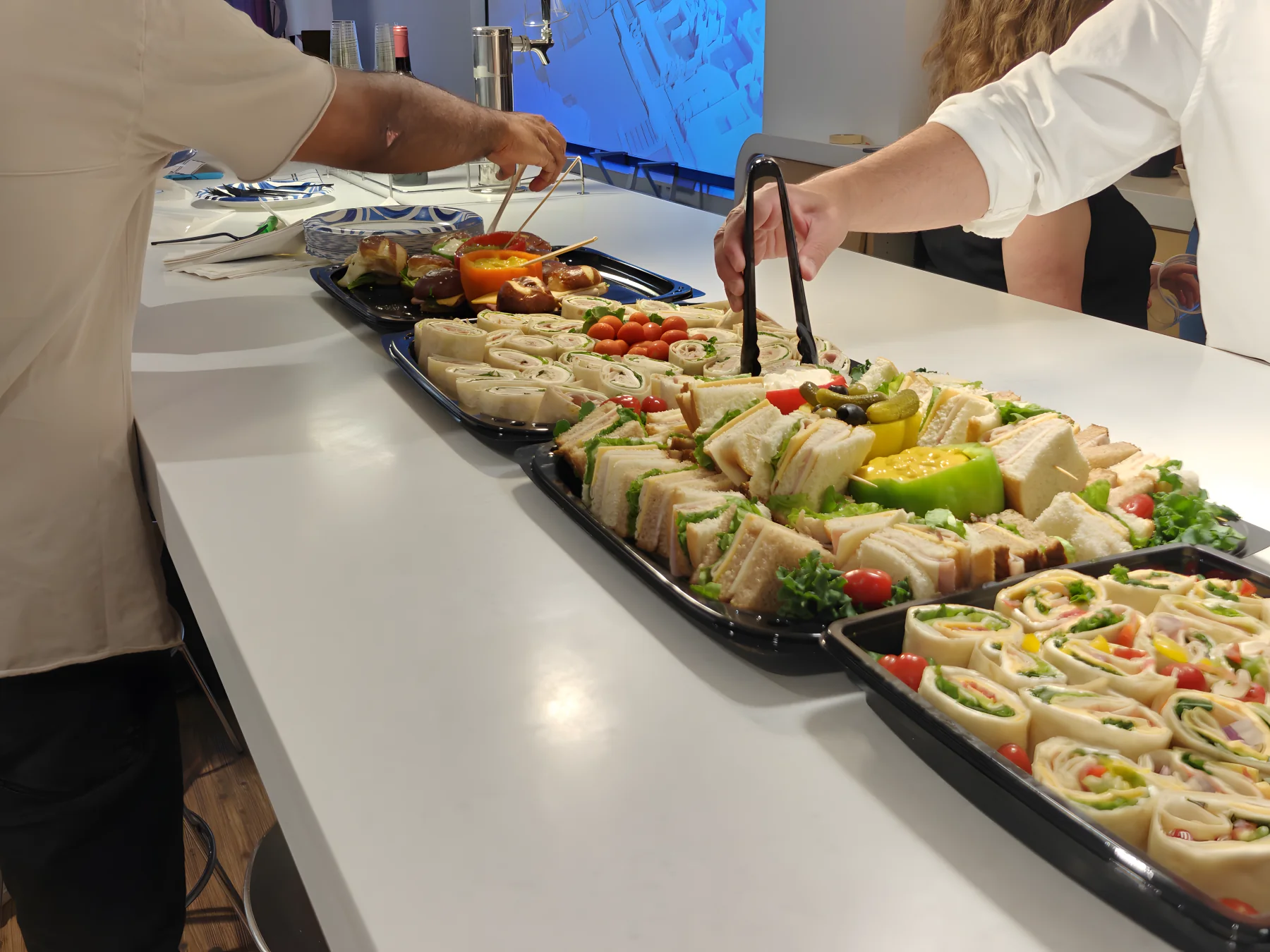 ChiPMA attendees reaching for sandwiches and wraps at a community event